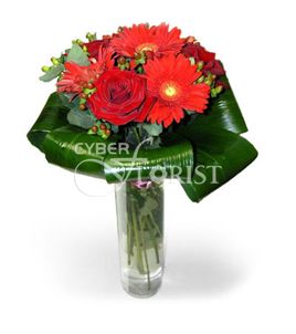 arrangement of gerberas and roses in a vase