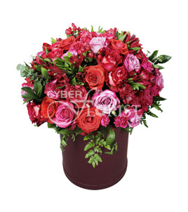 pink roses carnations and alstroemerias in a box. Madrid